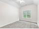 A spare bedroom featuring neutral colored paint and carpeted flooring at 14426 Harvington Dr, Huntersville, NC 28078