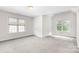 Spacious bedroom with lots of natural light from two large windows and neutral color scheme at 14426 Harvington Dr, Huntersville, NC 28078