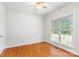 This bedroom features hardwood floors, a ceiling fan, and a window at 14426 Harvington Dr, Huntersville, NC 28078