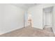 Bright bedroom features neutral carpet, fresh white walls, and trim with access to the upper floor at 14426 Harvington Dr, Huntersville, NC 28078