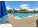 Beautiful community pool with blue umbrellas and marked swimming lanes on a bright, sunny day at 14426 Harvington Dr, Huntersville, NC 28078