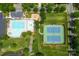 An aerial perspective captures the community pool area with its tennis courts, pool, splash pad and meticulously landscaped surroundings at 14426 Harvington Dr, Huntersville, NC 28078
