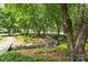 Picturesque creek surrounded by mature trees and landscaping offering a tranquil setting at 14426 Harvington Dr, Huntersville, NC 28078