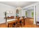 Formal dining room featuring hardwood floors, chandelier, and elegant decor at 14426 Harvington Dr, Huntersville, NC 28078