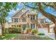 Charming brick home with lush landscaping, white shutters, and a welcoming front porch at 14426 Harvington Dr, Huntersville, NC 28078