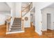 Inviting foyer with hardwood floors and an elegant staircase at 14426 Harvington Dr, Huntersville, NC 28078