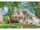 Attractive two-story home with brick facade, a well-kept lawn, and an attached garage at 14426 Harvington Dr, Huntersville, NC 28078