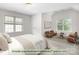 Virtually staged main bedroom with natural light and conversation space at 14426 Harvington Dr, Huntersville, NC 28078