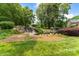 Scenic pond with a waterfall feature, lush greenery, and a bench for relaxing at 14426 Harvington Dr, Huntersville, NC 28078