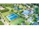 Aerial view showcasing the community pool, playground, tennis courts, pond, and clubhouse at 16028 Hallaton Dr, Huntersville, NC 28078