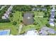 Aerial view of a pond with a fountain surrounded by lush landscaping and neighborhood amenities at 16028 Hallaton Dr, Huntersville, NC 28078