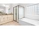 Bright bathroom features a soaking tub, separate shower, double vanity and neutral toned tile flooring at 16028 Hallaton Dr, Huntersville, NC 28078