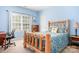 Comfortable bedroom with light blue walls, natural light, and rustic wood bed frame at 16028 Hallaton Dr, Huntersville, NC 28078