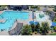 Aerial view of a community pool featuring a large pool, a splash pad, and lounge seating at 16028 Hallaton Dr, Huntersville, NC 28078