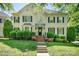 Charming two-story home with black shutters and a beautifully landscaped front yard at 16028 Hallaton Dr, Huntersville, NC 28078