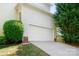 Attached two-car garage with a wide driveway, offering ample parking space at 16028 Hallaton Dr, Huntersville, NC 28078