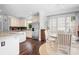 Bright eat-in kitchen features granite countertops, stainless appliances, and hardwood floors at 16028 Hallaton Dr, Huntersville, NC 28078