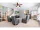 Large living room with hardwood stairs, TV, and multiple sitting chairs at 16028 Hallaton Dr, Huntersville, NC 28078