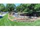Beautiful water feature with multiple falls, mature landscaping, and colorful flower beds at 16028 Hallaton Dr, Huntersville, NC 28078
