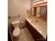 Bathroom featuring a vanity with storage, a mirror with vanity lights, and a toilet at 1623 Arbor Way, Albemarle, NC 28001