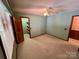 Bedroom features green walls, carpet, ceiling fan, and an open closet for storage at 1623 Arbor Way, Albemarle, NC 28001
