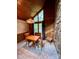 Inviting dining area featuring wood paneling, stone accents, and a charming chandelier at 1623 Arbor Way, Albemarle, NC 28001