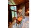Cozy dining area featuring wood paneling, stone accent wall and contemporary chandelier at 1623 Arbor Way, Albemarle, NC 28001