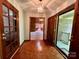 Inviting entryway with beautiful wood floors and light fixture, leading into the living area at 1623 Arbor Way, Albemarle, NC 28001