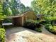 Brick home featuring a covered carport and a walkway surrounded by greenery at 1623 Arbor Way, Albemarle, NC 28001