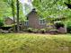 Charming brick home with well-maintained lawn, mature trees, and lush landscaping at 1623 Arbor Way, Albemarle, NC 28001