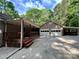 Brick house featuring a covered porch, an attached two-car garage, and a carport at 1623 Arbor Way, Albemarle, NC 28001