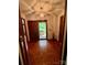 Foyer with parquet floors, chandelier, and views to front yard at 1623 Arbor Way, Albemarle, NC 28001