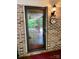 Charming brick entryway with a glass door leading to a covered porch at 1623 Arbor Way, Albemarle, NC 28001