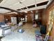 View of spacious garage with concrete floors, wood paneling, and ample storage space at 1623 Arbor Way, Albemarle, NC 28001