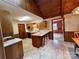 Cozy kitchen with a breakfast bar and wooden cabinets, seamlessly connects to the dining area at 1623 Arbor Way, Albemarle, NC 28001
