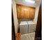 Functional laundry room with cabinetry above side-by-side washer and dryer at 1623 Arbor Way, Albemarle, NC 28001