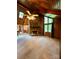 Bright living room features a stone fireplace, wood paneling, and large windows at 1623 Arbor Way, Albemarle, NC 28001