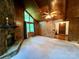 Spacious living room featuring a stone fireplace, wood-paneled walls, and large windows with natural light at 1623 Arbor Way, Albemarle, NC 28001