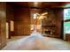 Bright living room features a stone fireplace, wood paneling, and large windows at 1623 Arbor Way, Albemarle, NC 28001