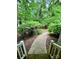 Landscaped walkway leading to the home's entrance, surrounded by trees and shrubs at 1623 Arbor Way, Albemarle, NC 28001