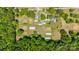 Bird's eye view of property featuring cultivated farmland with greenhouses, residence, and surrounding woodlands at 1687 Windy Hill Ln, Great Falls, SC 29055