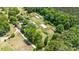 Expansive property with greenhouses and cultivated land adjacent to the residence, surrounded by mature trees at 1687 Windy Hill Ln, Great Falls, SC 29055