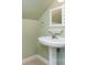 Charming half bathroom with a pedestal sink and decorative mirror adding character at 1687 Windy Hill Ln, Great Falls, SC 29055
