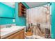 Cozy bathroom with single vanity, storage cabinet, decorative wall mirror, and tiled shower at 1687 Windy Hill Ln, Great Falls, SC 29055