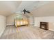 Cozy bedroom featuring a ceiling fan, a window, and a small fireplace for added comfort at 1687 Windy Hill Ln, Great Falls, SC 29055