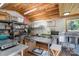 Spacious commercial kitchen with wooden ceiling, stainless steel tables and sink, and ample shelving for storage at 1687 Windy Hill Ln, Great Falls, SC 29055