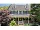 Welcoming two-story home with covered porch, adorned with lush greenery and tasteful decorations at 1687 Windy Hill Ln, Great Falls, SC 29055