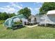 Exterior view of greenhouses, perfect for gardening and plant cultivation in a backyard setting at 1687 Windy Hill Ln, Great Falls, SC 29055