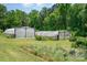 Exterior view of greenhouses, perfect for gardening and plant cultivation in a backyard setting at 1687 Windy Hill Ln, Great Falls, SC 29055