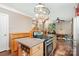 Open-concept kitchen features a gas range and hanging pot rack above the island at 1687 Windy Hill Ln, Great Falls, SC 29055